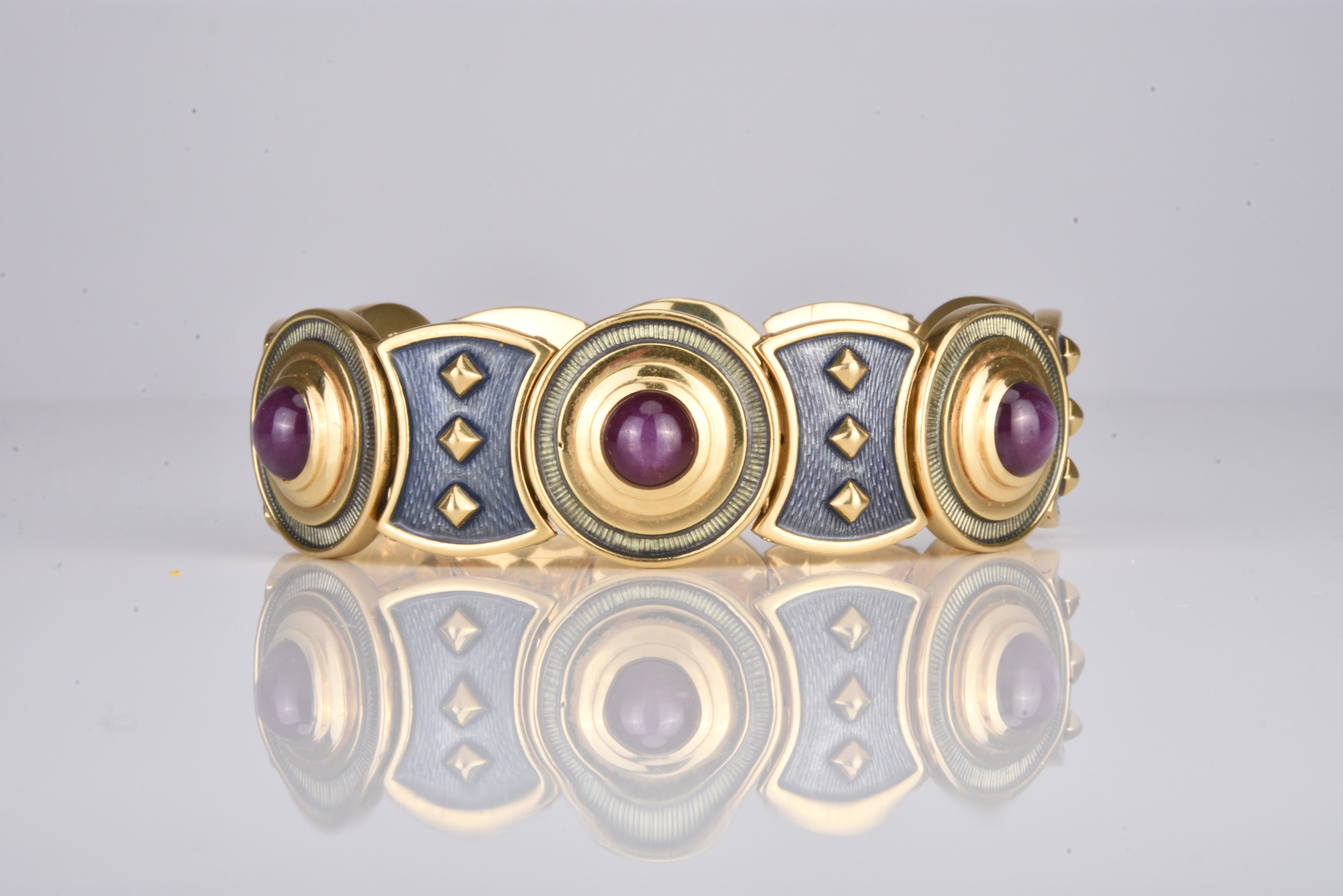 This 18ct gold star ruby and enamel bracelet by Leo De Vroomen sold for £5,100. Halls Fine Art Shrewsbury